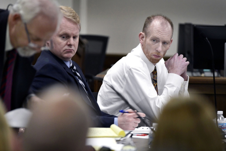 FILE - Chad Isaak, right, of Washburn, sits with his defense team during the third day of his murder trial at the Morton County Courthouse in Mandan, N.D., on Wednesday, Aug. 4, 2021. Authorities say Isaak, convicted in a 2019 quadruple slaying, has killed himself in prison. Isaak was appealing his convictions in the killings of the owner of a Mandan property management business and three workers there.