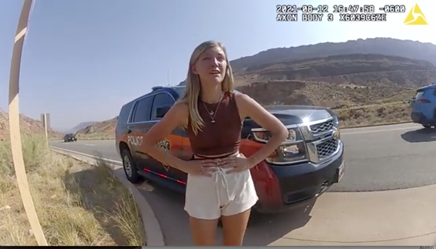 FILE- In this image taken from police body camera video provided by The Moab Police Department, Gabrielle "Gabby" Petito talks to a police officer after police pulled over the van she was traveling in with her boyfriend, Brian Laundrie, near the entrance to Arches National Park on Aug. 12, 2021. The family of Petito filed a notice of claim Monday, Aug. 8, 2022, of plans to file a wrongful death lawsuit against the tourist town of Moab, Utah, over police officers' handling of an encounter with Petito and her boyfriend weeks she was found dead in Wyoming.