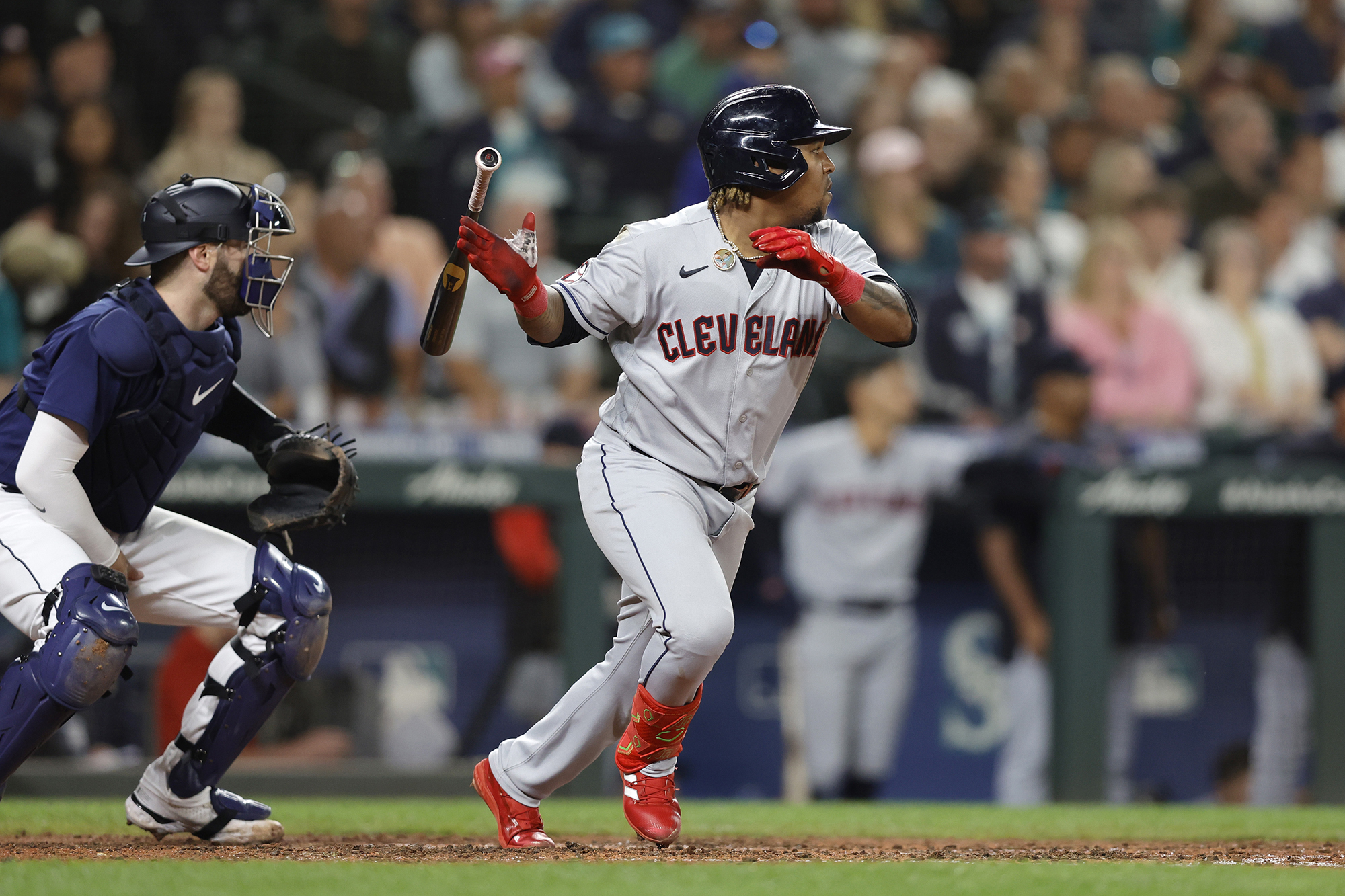 Cleveland Guardians' Jose Ramirez, right, watches his RBI-double against the Seattle Mariners during the eighth inning of a baseball game, Saturday, Aug. 27, 2022, in Seattle.
