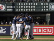 Seattle Mariners infielders, including third baseman Eugenio Suarez (28) and second baseman Adam Frazier, second from, right, celebrate after a baseball game against the Cleveland Guardians, Thursday, Aug. 25, 2022, in Seattle.