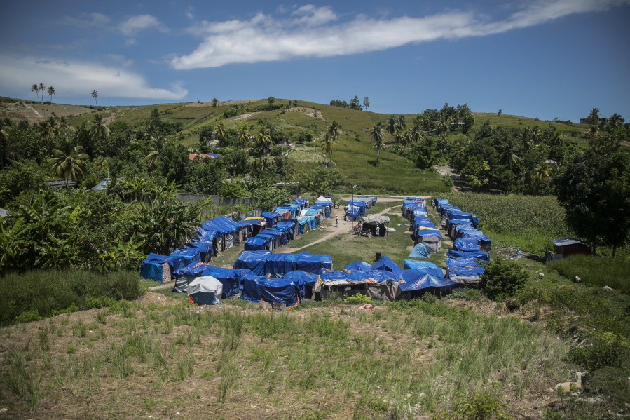 Blue tarps serve as roof coverings in Camp Devirel set up by earthquake refugees in Les Cayes, Haiti, Wednesday, Aug. 17, 2022. A year after a magnitude-7.2 quake hit southern Haiti, the hundreds that were left homeless are still living in the same makeshift tents.