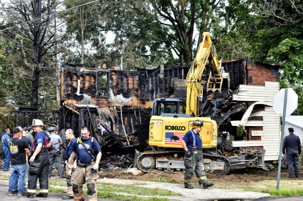 Crews work to demolish a house that was destroyed by a fatal fire on the 700 block of 1st Street in Nescopeck, Pa., Friday, Aug. 5, 2022. Multiple people are feared dead after a house fire early Friday in northeastern Pennsylvania, according to a volunteer firefighter who responded and said the victims were his relatives. A criminal investigation is underway, police said.