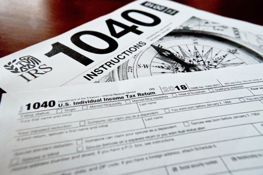 FILE- Internal Revenue Service taxes forms are seen on Feb. 13, 2019. The flagship climate change and health care bill passed by Democrats and soon to be signed by President Biden will have U.S. taxpayers one step closer to a government-operated electronic free-file tax return system.