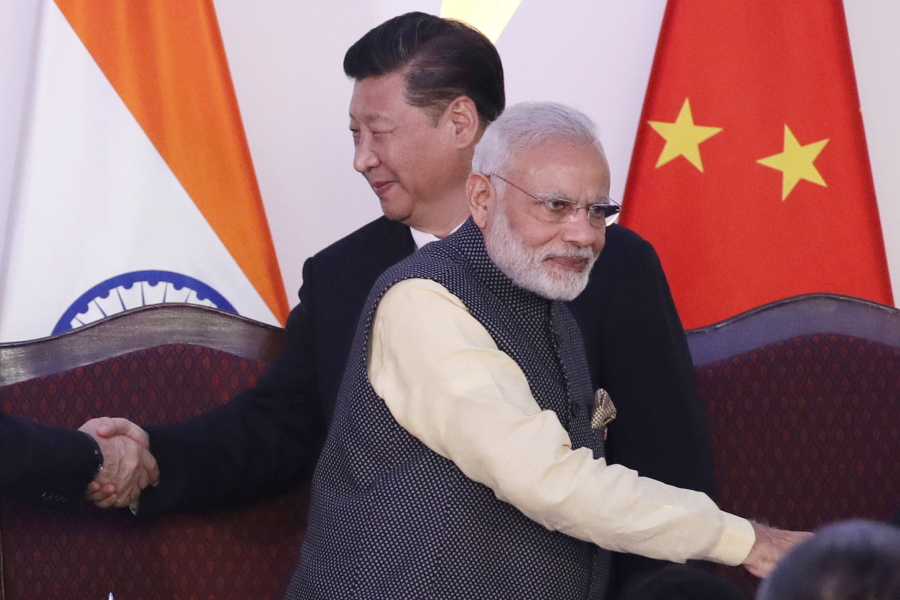 FILE- Indian Prime Minister Narendra Modi, front and Chinese President Xi Jinping shake hands with leaders at the BRICS summit in Goa, India, Oct. 16, 2016. India on Friday, Aug. 12, 2022, criticized China's decision to block the imposition of U.N. sanctions sought by it and the United States against the deputy chief of Jaish-e-Mohammad, a Pakistan-based extremist group designated by the United Nations as a terrorist organization.