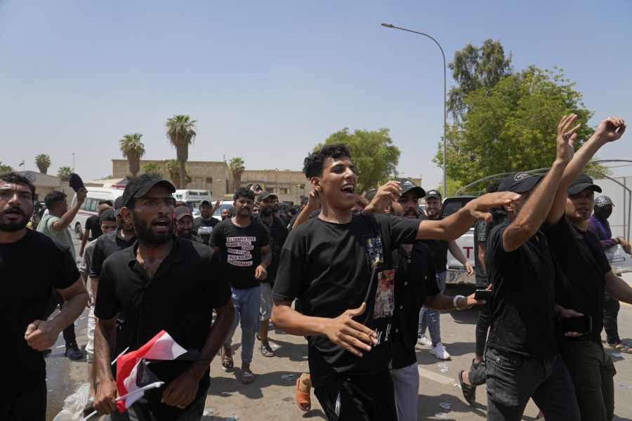Supporters of Iraqi Shiite cleric Muqtada al-Sadr protest in front the Supreme Judicial Council, in Baghdad, Iraq, Tuesday, Aug. 23, 2022. Dozens of supporters of al-Sadr, an influential Shiite cleric in Iraq, rallied on Tuesday in Baghdad's heavily-fortified Green Zone, demanding the dissolution of parliament and early elections. The demonstration underscored how intractable Iraq's latest political crisis has become.