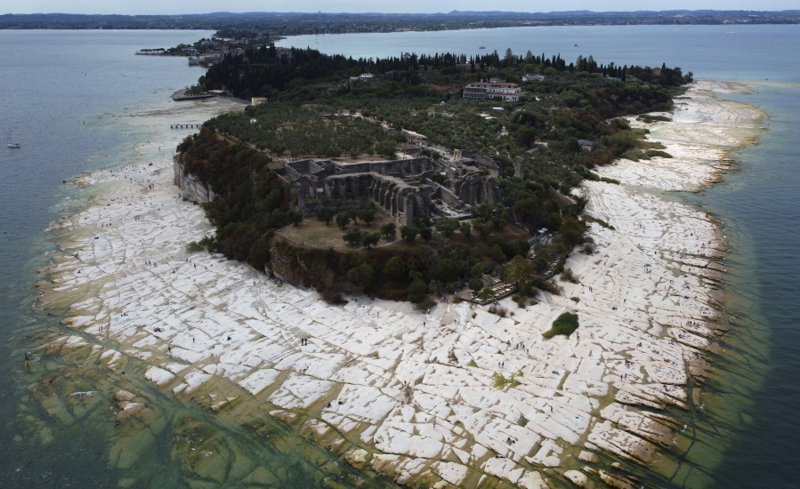 A view of the Sirmione Peninsula, on Lake Garda in Italy, on Friday shows that the water level has dropped critically during the severe drought, resulting in rocks that used to be underwater being exposed around the peninsula.