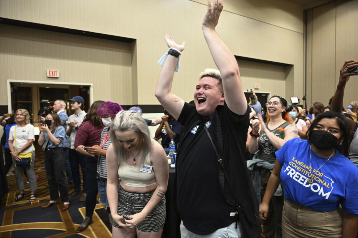 FILE - Allie Utley, left, and Jae Moyer, center, of Overland Park, Kan., reacts during a primary watch party Aug. 2, 2022, at the Overland Park Convention Center. A notable increase in turnout among Democrats and independents and a surprising shift in Republican-leaning counties contributed to the overwhelming support of abortion rights last week in traditionally conservative Kansas, according to a detailed Associated Press analysis of the voting results.