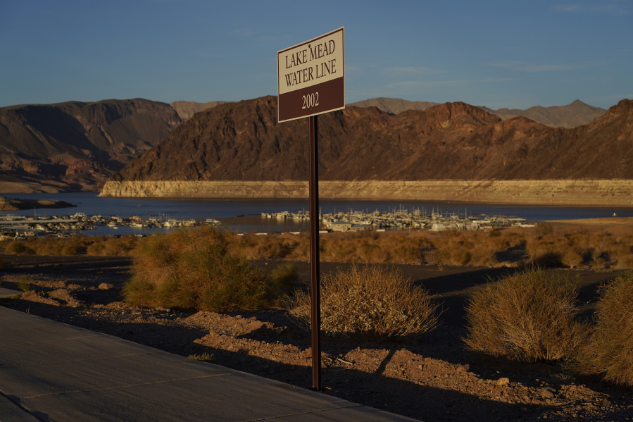 A sign marks the water line from 2002 near Lake Mead at the Lake Mead National Recreation Area, Saturday, July 9, 2022, near Boulder City, Nev. The largest U.S. reservoir has shrunken to a record low amid a punishing drought and the demands of 40 million people in seven states who are sucking the Colorado River dry.