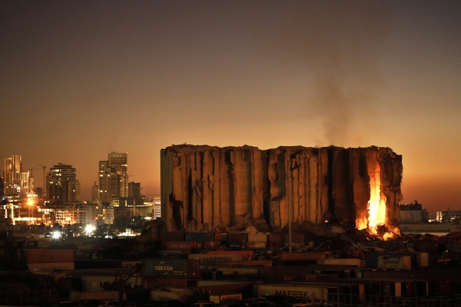 FILE - Silos in the north block of the Beirut Port, that were destroyed by a massive explosion in 2020, have caught fire due to fermented grains in Beirut, Lebanon, Sunday, July 24, 2022. It has been two years since a warehouse full of ammonium nitrate at Beirut's port exploded, destroying large parts of the city, killing more than 215 people and injuring thousands. Many families are losing hope of ever finding justice.