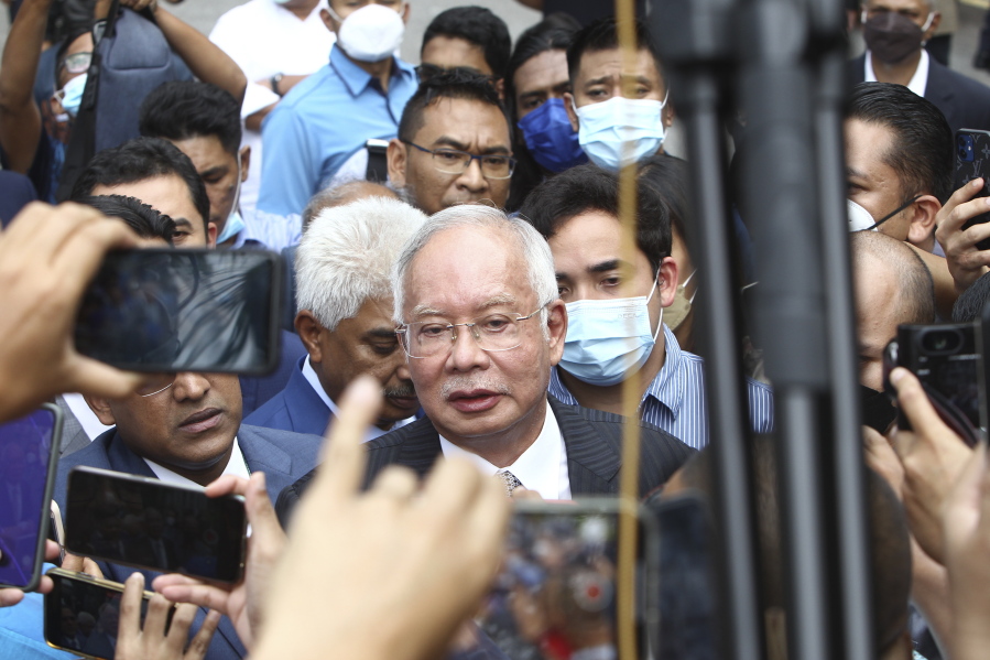 Former Malaysian Prime Minister Najib Razak, center, speaks to supporters outside at Court of Appeal in Putrajaya, Malaysia Tuesday, Aug. 23, 2022. Malaysia's top court has upheld Najib's conviction and 12-year jail sentence in a graft case linked to the looting of the 1MDB state fund. Najib's loss in his final appeal means he will have to begin serving his sentence immediately, becoming the first former prime minister to be jailed.