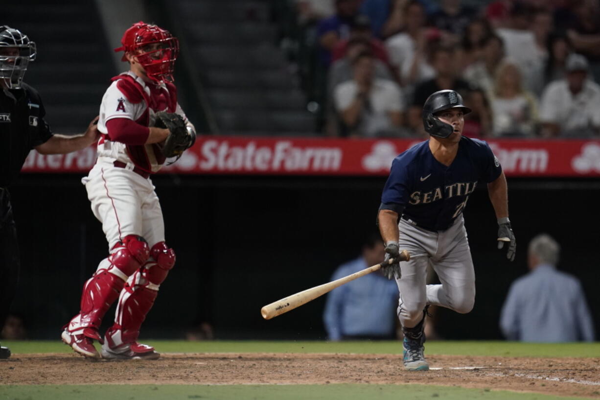 Seattle Mariners' Adam Frazier watches his two-run triple during the ninth inning of the team's baseball game against the Los Angeles Angels onTuesday, Aug. 16, 2022, in Anaheim, Calif.