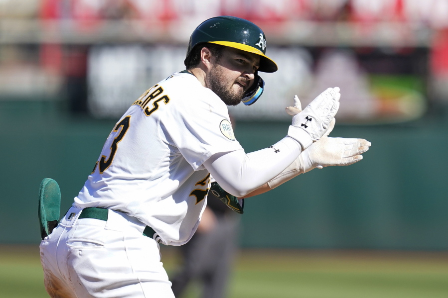 Oakland Athletics' Shea Langeliers celebrates after hitting an RBI-triple against the Seattle Mariners during the eighth inning of a baseball game in Oakland, Calif., Sunday, Aug. 21, 2022. (AP Photo/Godofredo A.