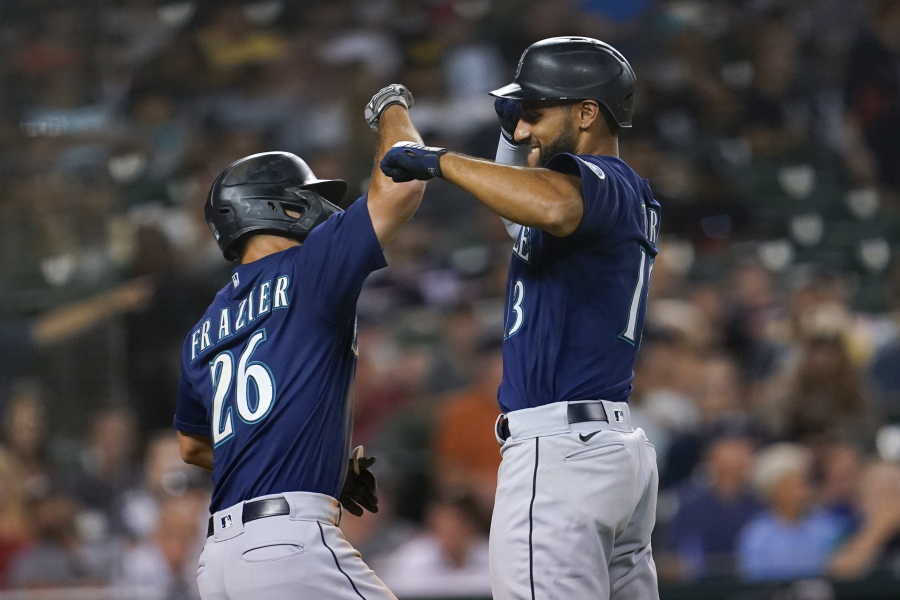 Seattle Mariners' Abraham Toro, right, celebrates his two-run home run with Adam Frazier (26) in the seventh inning of a baseball game against the Detroit Tigers in Detroit, Wednesday, Aug. 31, 2022.