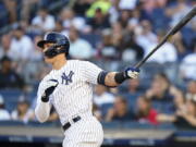 New York Yankees' Aaron Judge follows through on a double during the first inning of a baseball game against the Seattle Mariners, Monday, Aug. 1, 2022, in New York.