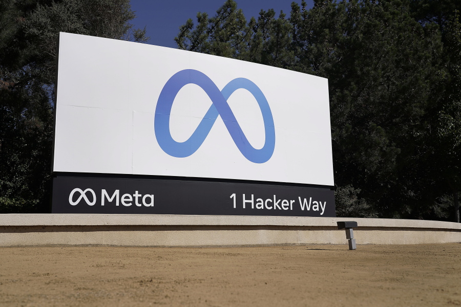 FILE - Facebook's Meta logo sign is seen at the company headquarters in Menlo Park, Calif., on, Oct. 28, 2021. Facebook owner Meta is quietly curtailing some of the safeguards designed to thwart voting misinformation or foreign interference in elections even as the U.S. Midterms approach.
