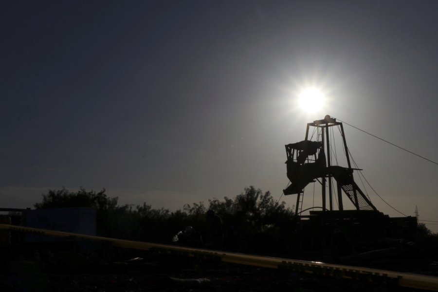 The sun set behind a tower that is used by the the rescue team to enter to the mine where miners are trapped in a collapsed and flooded coal mine in Sabinas, Coahuila state, Mexico, Thursday, Aug. 4, 2022. The collapse occurred after the miners breached a neighboring area filled with water on Wednesday, officials said.