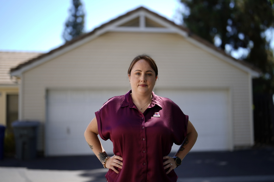 Kate Needham, a veteran who co-founded the nonprofit Armed Forces Housing Advocates, looks on in a housing complex, Tuesday, Aug. 16, 2022, in San Diego. Needham's group supplies microgrants to military families in need, some of whom have resorted to food banks because their salaries do not cover such basics. "I don't think civilians really understand -- they might think we're living in free housing and just having a great time, making lots of money.
