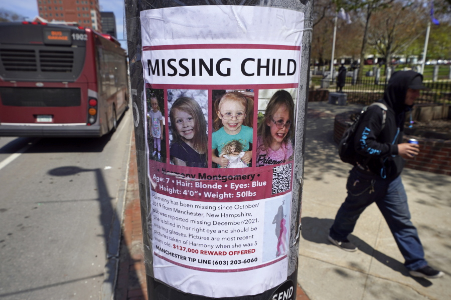 FILE - A man walks past the "missing child" poster for Harmony Montgomery on Thursday, May 5, 2022, in Manchester, N.H. The search for Montgomery, a New Hampshire girl who disappeared in 2019 at age 5 but was not reported missing until late last year, is now considered a homicide investigation, authorities said Thursday, Aug. 11, 2022.