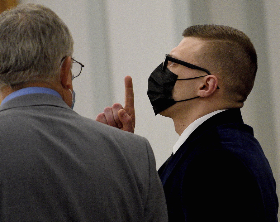 Volodymyr Zhukovskyy of West Springfield, Mass., gestures as the not guilty verdict is read while standing with his attorney, Steve Mirkin, at Coos County Superior Court in Lancaster, N.H., Tuesday, Aug. 9, 2022. The commercial truck driver was charged with negligent homicide in the deaths of seven motorcycle club members in a 2019 crash in Randolph, N.H.