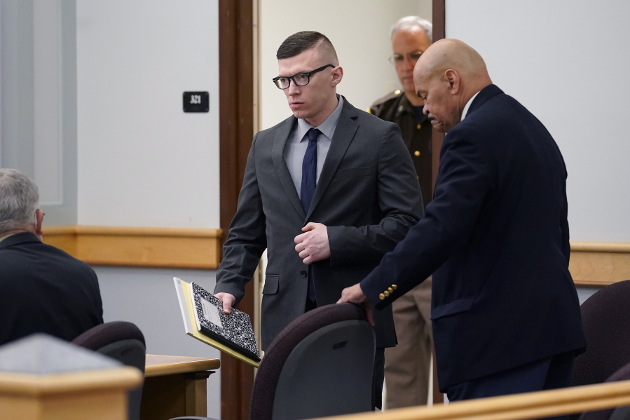 Volodymyr Zhukovskyy, of West Springfield, Mass., center, charged with negligent homicide in the deaths of seven motorcycle club members in a 2019 crash, enters a courtroom at Coos County Superior Court, in Lancaster, N.H., Monday, July 25, 2022, before a scheduled visit to the crash scene. Zhukovskyy has pleaded not guilty to multiple counts of negligent homicide, manslaughter, reckless conduct and driving under the influence in the June 21, 2019, crash.
