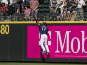 Seattle Mariners rightfielder Mitch Haniger cannot get to a homerun ball hit by Washington Nationals' Ildemaro Vargas during the ninth inning of a baseball game, Wednesday, Aug. 24, 2022, in Seattle.
