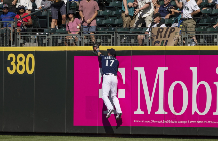 Seattle Mariners rightfielder Mitch Haniger cannot get to a homerun ball hit by Washington Nationals' Ildemaro Vargas during the ninth inning of a baseball game, Wednesday, Aug. 24, 2022, in Seattle.