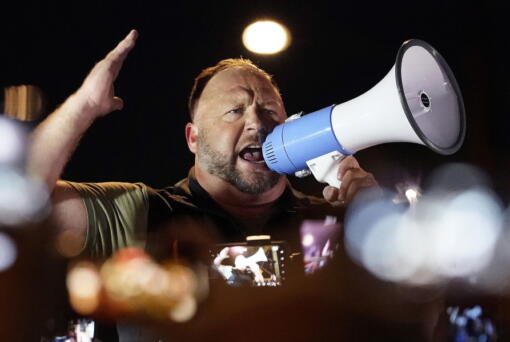 FILE - Infowars host and conspiracy theorist Alex Jones rallies pro-Trump supporters, Nov. 5, 2020, in Phoenix. A federal bankruptcy judge has cleared the way for a defamation lawsuit, filed by relatives of some victims of the 2012 massacre at Sandy Hook Elementary School in Newtown, Connecticut, to proceed against Jones.