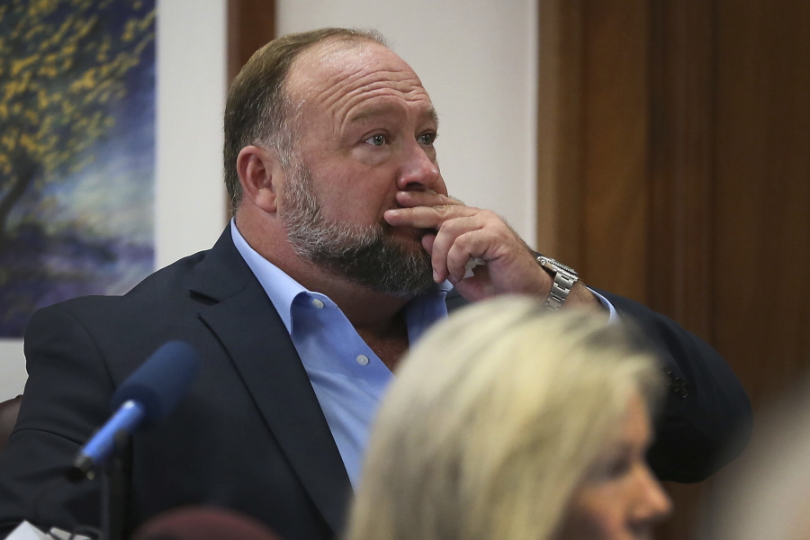 Alex Jones attempts to answer questions about his text messages asked by Mark Bankston, lawyer for Neil Heslin and Scarlett Lewis, during trial at the Travis County Courthouse in Austin, Wednesday Aug. 3, 2022.