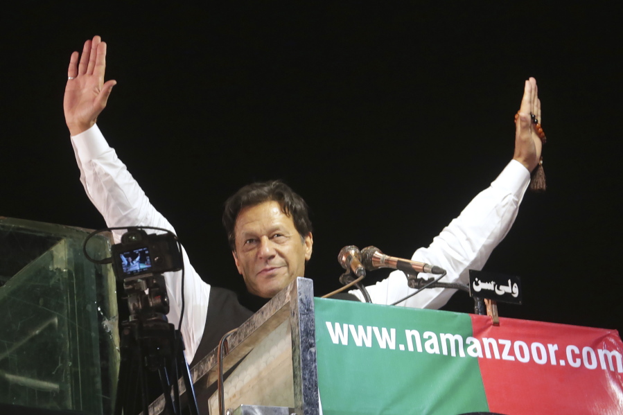 FILE - Former Pakistani Prime Minister Imran Khan waves to his supporters during an anti government rally, in Lahore, Pakistan, April 21, 2022. Pakistani police have filed terrorism charges against Khan, authorities said Monday, Aug. 22, 2022, escalating political tensions in the country as he holds mass rallies seeking to return to office. (AP Photo/K.M.