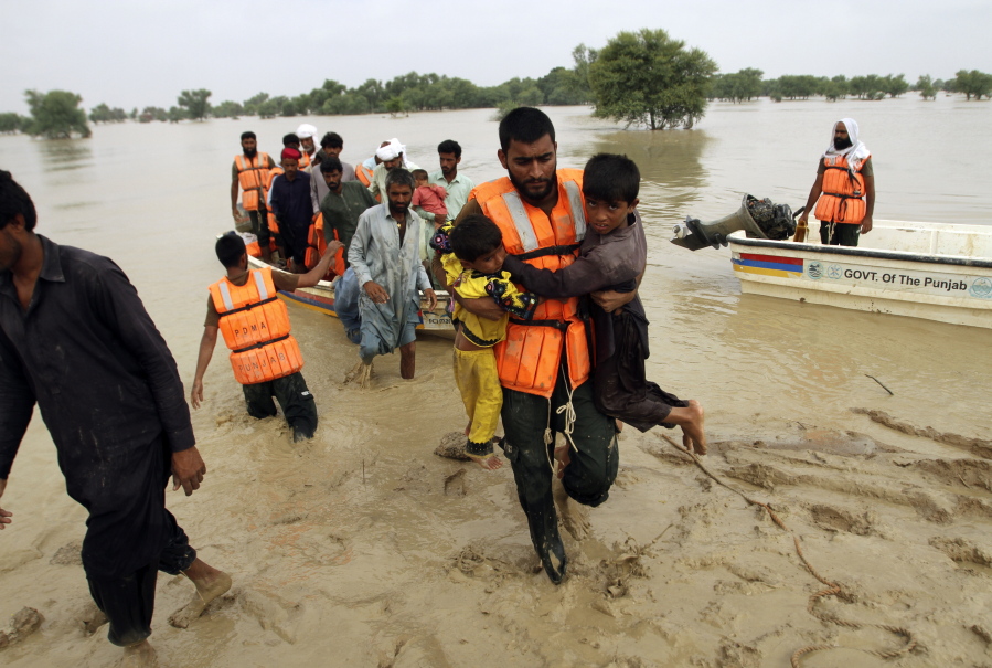 Army troops evacuate people from a flood-hit area in Rajanpur, district of Punjab, Pakistan, Saturday, Aug. 27, 2022. Officials say flash floods triggered by heavy monsoon rains across much of Pakistan have killed nearly 1,000 people and displaced thousands more since mid-June.