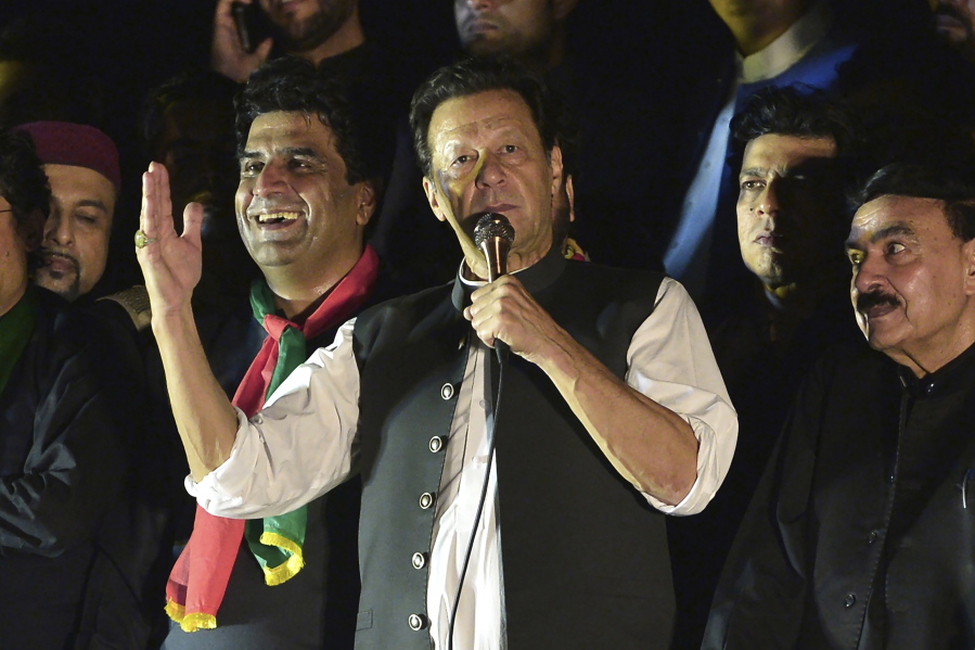 Pakistan's former Prime Minister Imran Khan, center, addresses during an anti-government rally in Islamabad, Pakistan, Saturday, Aug. 20, 2022. A Pakistani court on Tuesday, Aug. 23, 2022, was expected to initiate contempt proceedings against Khan for threatening a judge in a recent rally speech as pressure on the ousted premier intensified with police raiding the apartment of his close aide in the capital, and taking the associate away for interrogation. (AP Photo/W.K.