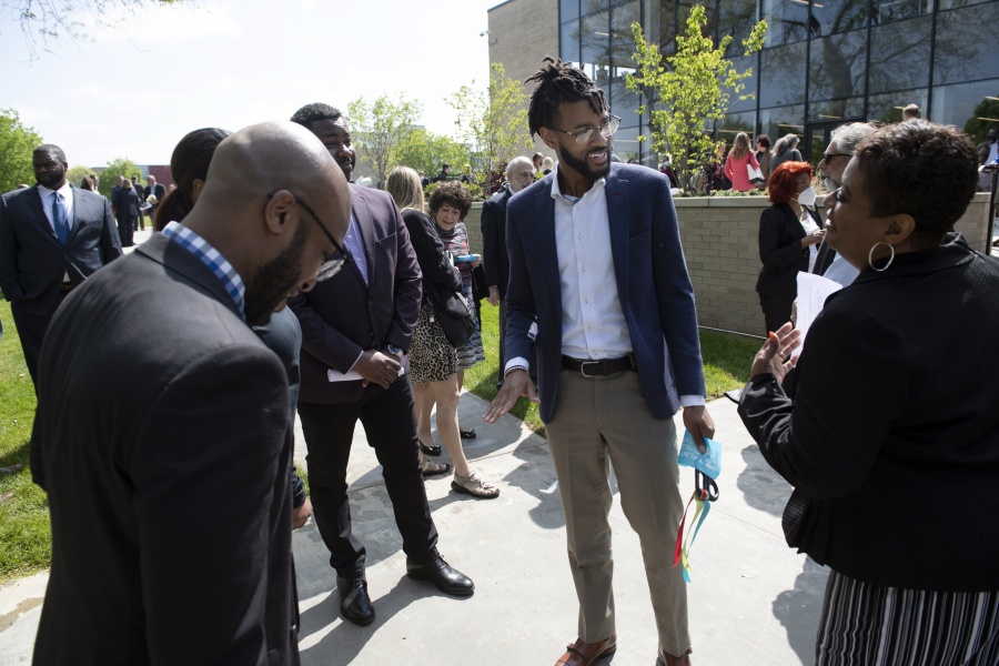 Community Foundation of Greater Flint CEO Isaiah Oliver circulates during a library opening in Flint, Mich., on Thursday, May 19, 2022. As the foundation's first Flint native and first Black leader since it was founded in 1988, Oliver works to build bridges between marginalized people and wealthy donors.