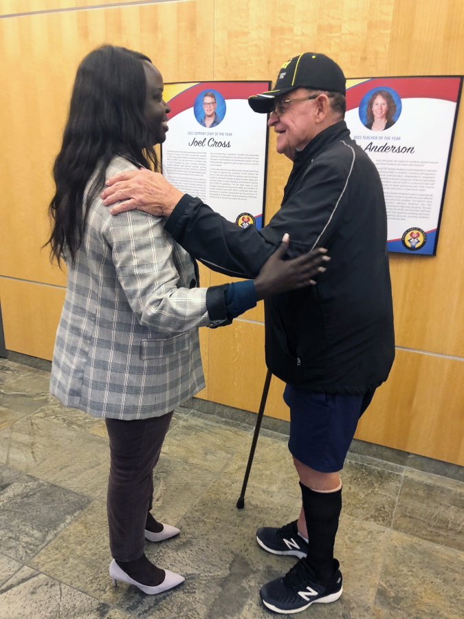 Nyamal Dei, a school board member in Fargo, N.D., is greeted by Vietnam veteran David Halcrow following a special meeting on Thursday, Aug. 18, 2022, to reconsider a decision by the previous board to eliminate reciting the Pledge of Allegiance before meetings. Halcrow apologized to Dei for a barrage of hate emails and voicemails she received following last week's decision to ax the pledge. Dei, the lone Black member on the board, was the only person to vote Thursday against reinstating the pledge.