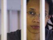 FILE - US Basketball player Brittney Griner looks through bars as she listens to the verdict standing in a cage in a courtroom in Khimki, outside Moscow, Russia, Thursday, Aug. 4, 2022. Lawyers for American basketball star Brittney Griner on Monday, Aug. 15, 2022 filed an appeal of her nine-year Russian prison sentence for drugs possession. Griner, a center for the Phoenix Mercury and a two-time Olympic gold medalist, was convicted on Aug. 4. She was arrested in February at Moscow's Sheremetyevo Airport after vape canisters containing cannabis oil were found in her luggage.