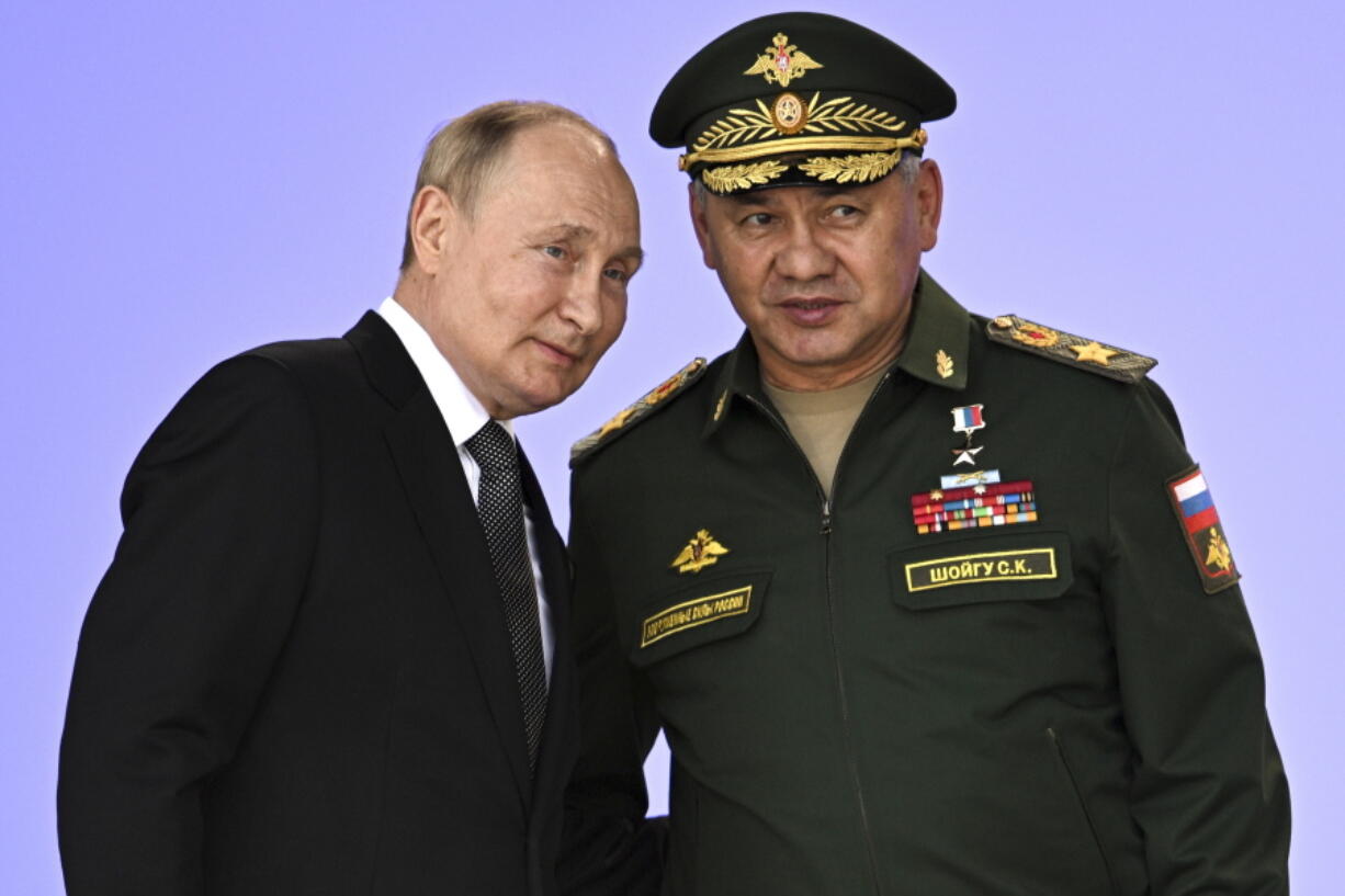Russia's President Vladimir Putin and Russian Defense Minister Sergei Shoigu attend the opening of the Army 2022 International Military and Technical Forum in the Patriot Park outside Moscow, Russia, Monday, Aug. 15, 2022. Putin vowed to strengthen Russia's military cooperation with its allies.