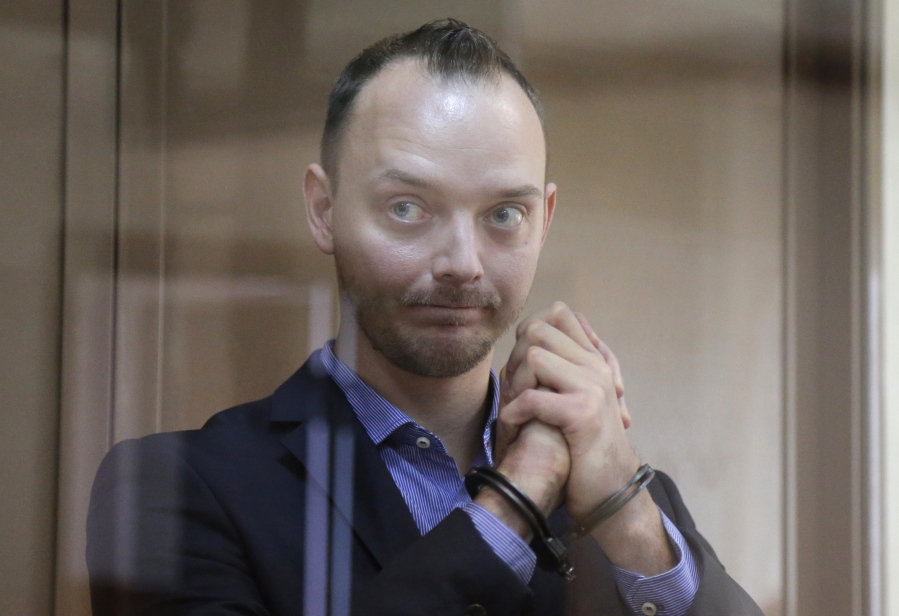 FILE - Ivan Safronov, an adviser to the director of Russia's state space corporation, stands in a cage in a courtroom in Moscow, Russia, on July 16, 2020. Prosecutors asked the court Tuesday, Aug. 30, 2022, to sentence Safronov to 24 years in prison.
