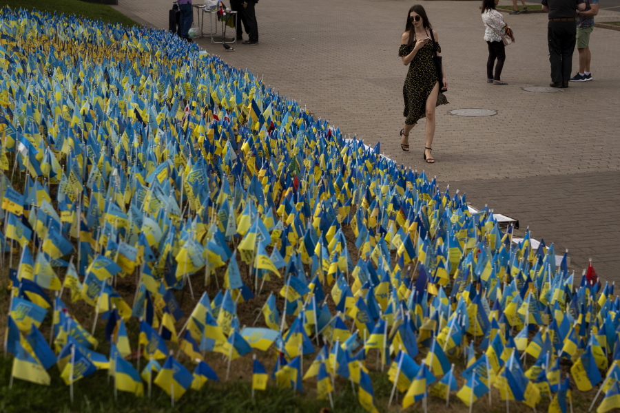Ukrainian flags to honor soldiers killed fighting Russian troops, are placed in a garden in Kiev's Independence Square, Ukraine, Sunday, Aug. 28, 2022.