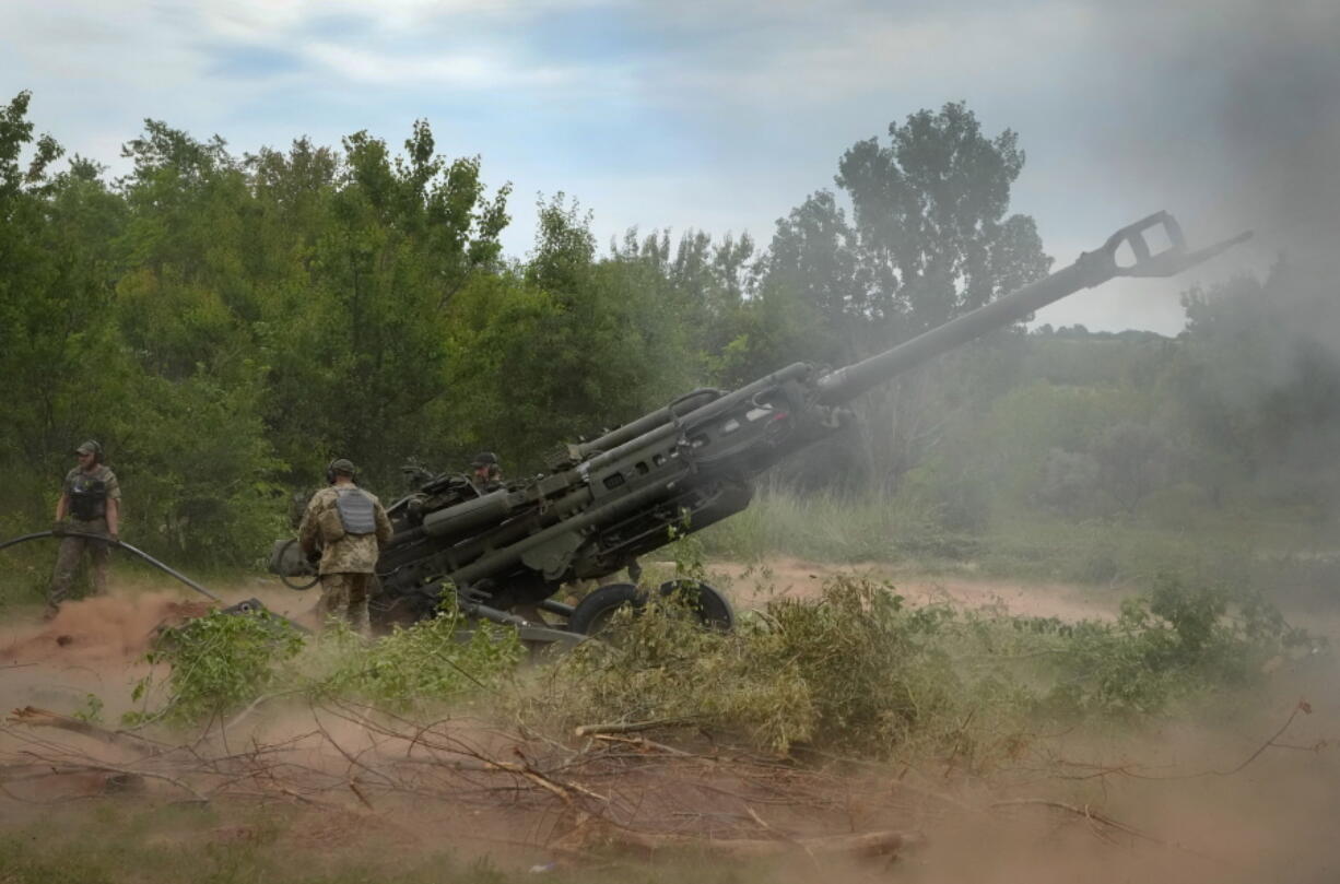 FILE - Ukrainian soldiers fire at Russian positions from a U.S.-supplied M777 howitzer in Ukraine's eastern Donetsk region, June 18, 2022. The deliveries of Western weapons have been crucial for Ukraine's efforts to fend off Russian attacks in the country's eastern industrial heartland of Donbas. The Western howitzers have some advantages compared to older Soviet-designed systems in the Russian and Ukrainian arsenals, but they require time for the Ukrainian crews to train how to operate them and their wide assortment poses obvious logistical challenges.