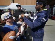 Seattle Seahawks running back Rashaad Penny signs autographs for fans after NFL football practice Wednesday, Aug. 3, 2022, in Renton, Wash. (AP Photo/Ted S.