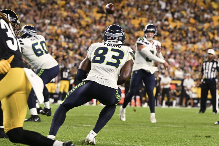 Seattle Seahawks quarterback Drew Lock, rear, throws a touchdown pass to wide receiver Dareke Young (83) against the Pittsburgh Steelers during the second half of an NFL preseason football game Saturday, Aug. 13, 2022, in Pittsburgh.