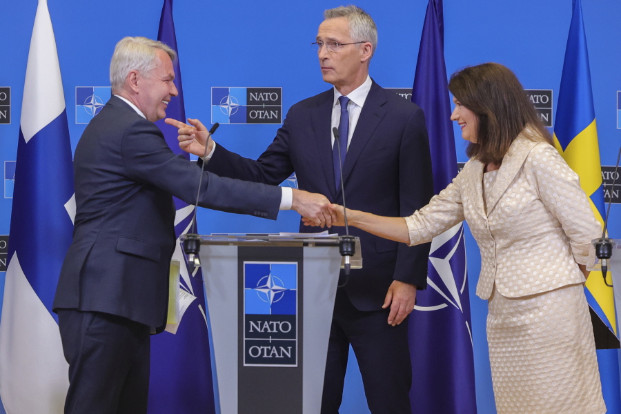 FILE - Finland's Foreign Minister Pekka Haavisto, left, Sweden's Foreign Minister Ann Linde, right, and NATO Secretary General Jens Stoltenberg attend a media conference after the signature of the NATO Accession Protocols for Finland and Sweden in the NATO headquarters in Brussels, July 5, 2022.