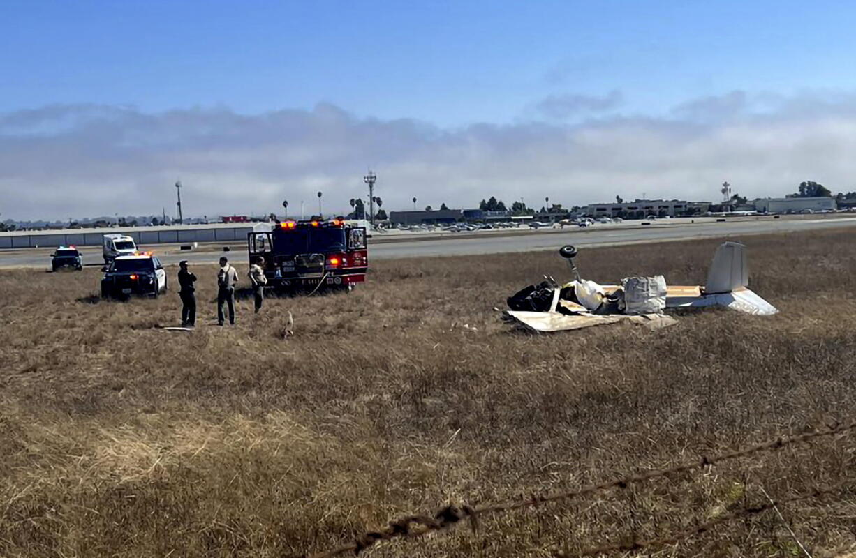 This photo provided by KION-TV shows multiple agencies responding to Watsonville Municipal Airport, northwest of Watsonville, in Santa Cruz County, Calif. after 2 planes attempting to land collided on Thursday, Aug. 18, 2022. Two planes collided in Northern California while trying to land at a local airport and at least two of the three occupants were killed.