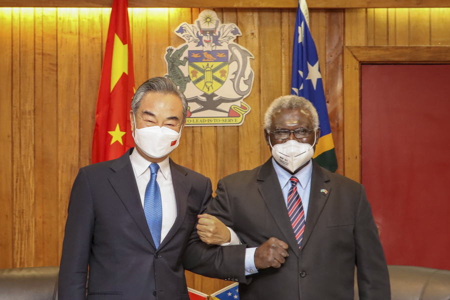 FILE -  In this photo released by Xinhua News Agency, Solomon Islands Prime Minister Manasseh Sogavare, right, locks arms with visiting Chinese Foreign Minister Wang Yi in Honiara, Solomon Islands on May 26, 2022. A U.S. coast guard cutter conducting patrols as part of an international mission to prevent illegal fishing was recently unable to get clearance for a scheduled port call in the Solomon Islands, according to reports, an incident that comes amid growing concerns of Chinese influence on the Pacific nation.