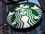 FILE - A Starbucks sign hangs outside a Starbucks coffee shop in downtown Pittsburgh on June 26, 2019.  The National Labor Relations Board says Starbucks is violating U.S. labor law by withholding pay hikes and other benefits from stores that have voted to unionize. The labor board's Seattle office filed the complaint late Wednesday, Aug. 24, 2022.  (AP Photo/Gene J.