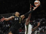 Las Vegas Aces forward A'ja Wilson (22) and Seattle Storm guard Jewell Loyd (24) battle for a rebound during the first half in Game 2 of a WNBA basketball semifinal playoff series Wednesday, Aug. 31, 2022, in Las Vegas.