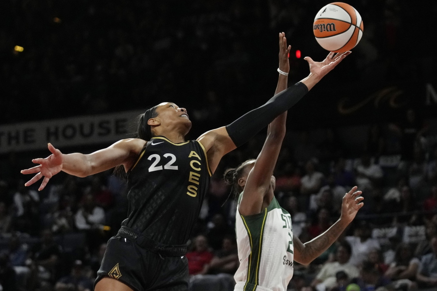 Las Vegas Aces forward A'ja Wilson (22) and Seattle Storm guard Jewell Loyd (24) battle for a rebound during the first half in Game 2 of a WNBA basketball semifinal playoff series Wednesday, Aug. 31, 2022, in Las Vegas.