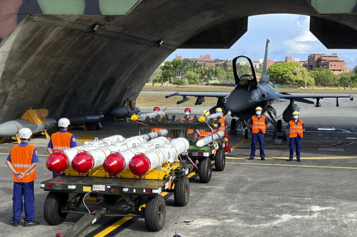 Military personnel stand next to Harpoon A-84, anti-ship missiles and AIM-120 and AIM-9 air-to-air missiles prepared for a weapon loading drills in front of a F16V fighter jet at the Hualien Airbase in Taiwan's southeastern Hualien county on Wednesday, Aug. 17, 2022. Taiwan is staging military exercises to show its ability to resist Chinese pressure to accept Beijing's political control over the island.