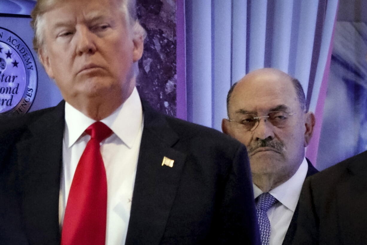 FILE - Allen Weisselberg, right, stands behind then President-elect Donald Trump during a news conference in the lobby of Trump Tower in New York, Jan. 11, 2017. Weisselberg, Trump's chief financial officer, is expected to plead guilty on Thursday, Aug. 18, 2022 to tax violations in a deal that would require him to testify about business practices at the former president's company.