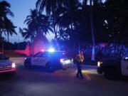 Police direct traffic outside an entrance to former President Donald Trump's Mar-a-Lago estate, Monday, Aug. 8, 2022, in Palm Beach, Fla. Trump said in a lengthy statement that the FBI was conducting a search of his Mar-a-Lago estate and asserted that agents had broken open a safe.