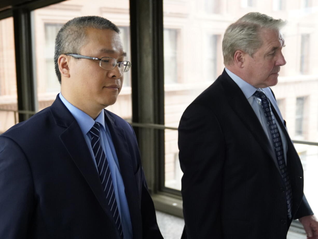 FILE - Former Minneapolis police officer Tou Thao, left, and his attorney Robert Paule arrive for sentencing for violating George Floyd's civil rights outside the Federal Courthouse Wednesday, July 27, 2022, in St. Paul, Minn. A judge has scheduled a hearing for Monday, Aug. 15, 2022, on the status of plea negotiations in the case of the two remaining officers awaiting trial on state charges in the murder of George Floyd. Thao and J. Alexander Kueng face a late October trial.